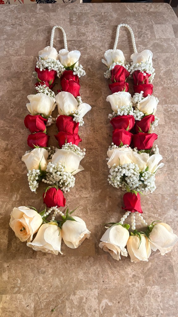 Pair of handmade red and cream rose garlands with baby's breath and pearl accents